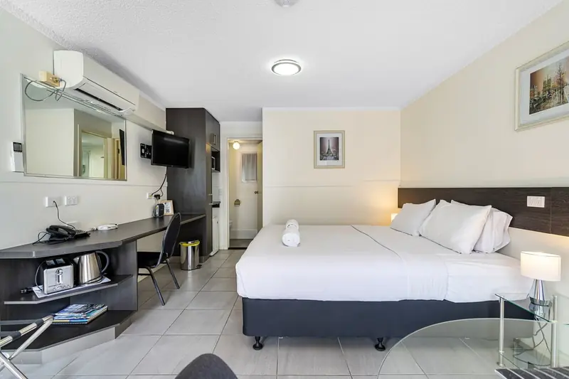 King bed and desk in a king motel room at Gallery Motel, Murwillumbah